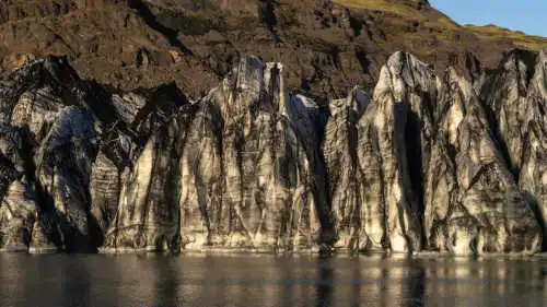 A family is posing and smiling on a glacier